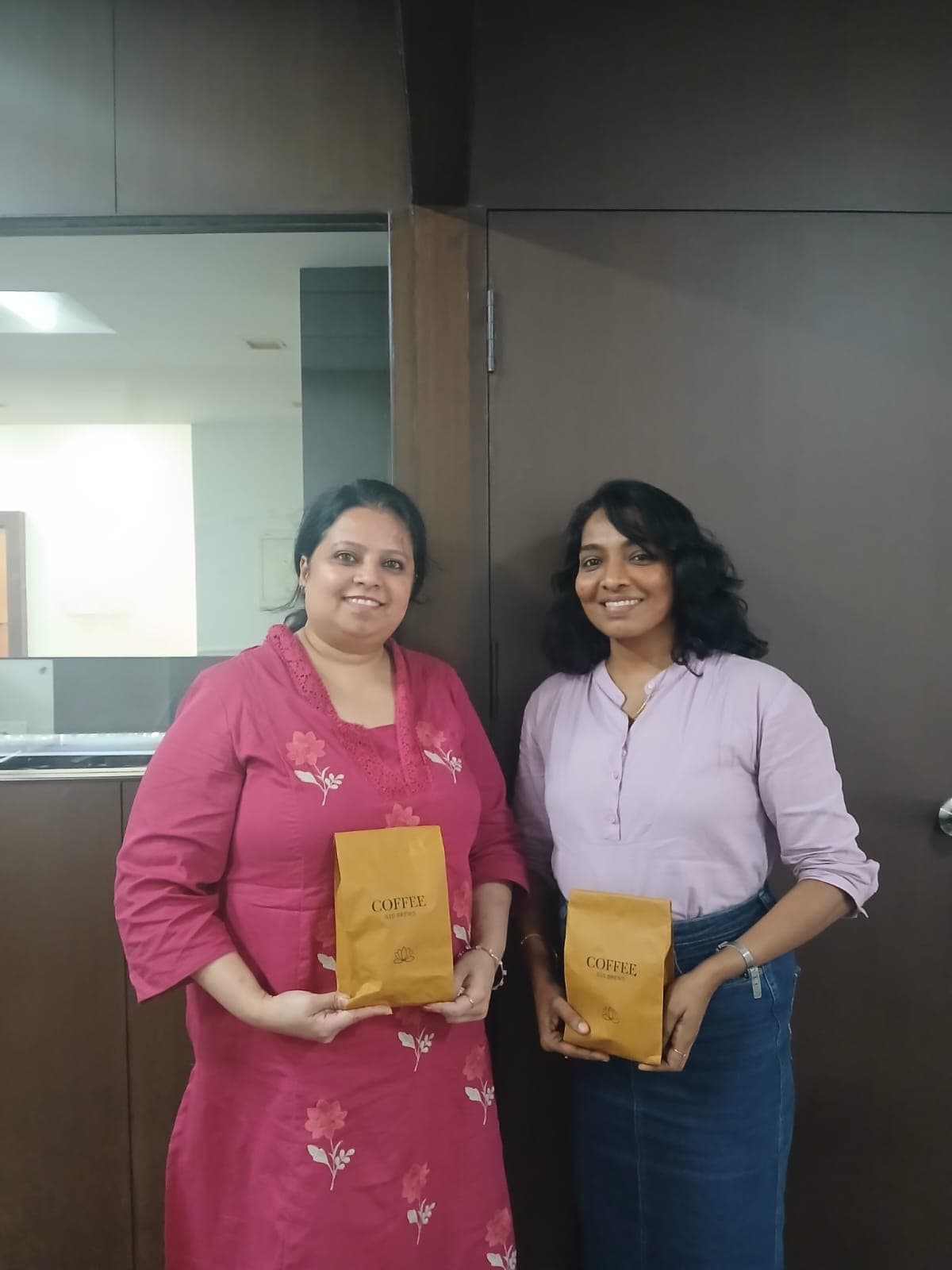 Two happy S10 Brews customers with coffee bags